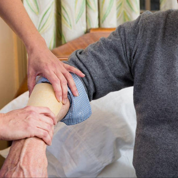 Wound Care Specialist adding Manuka Honey Dressing to patient's arm